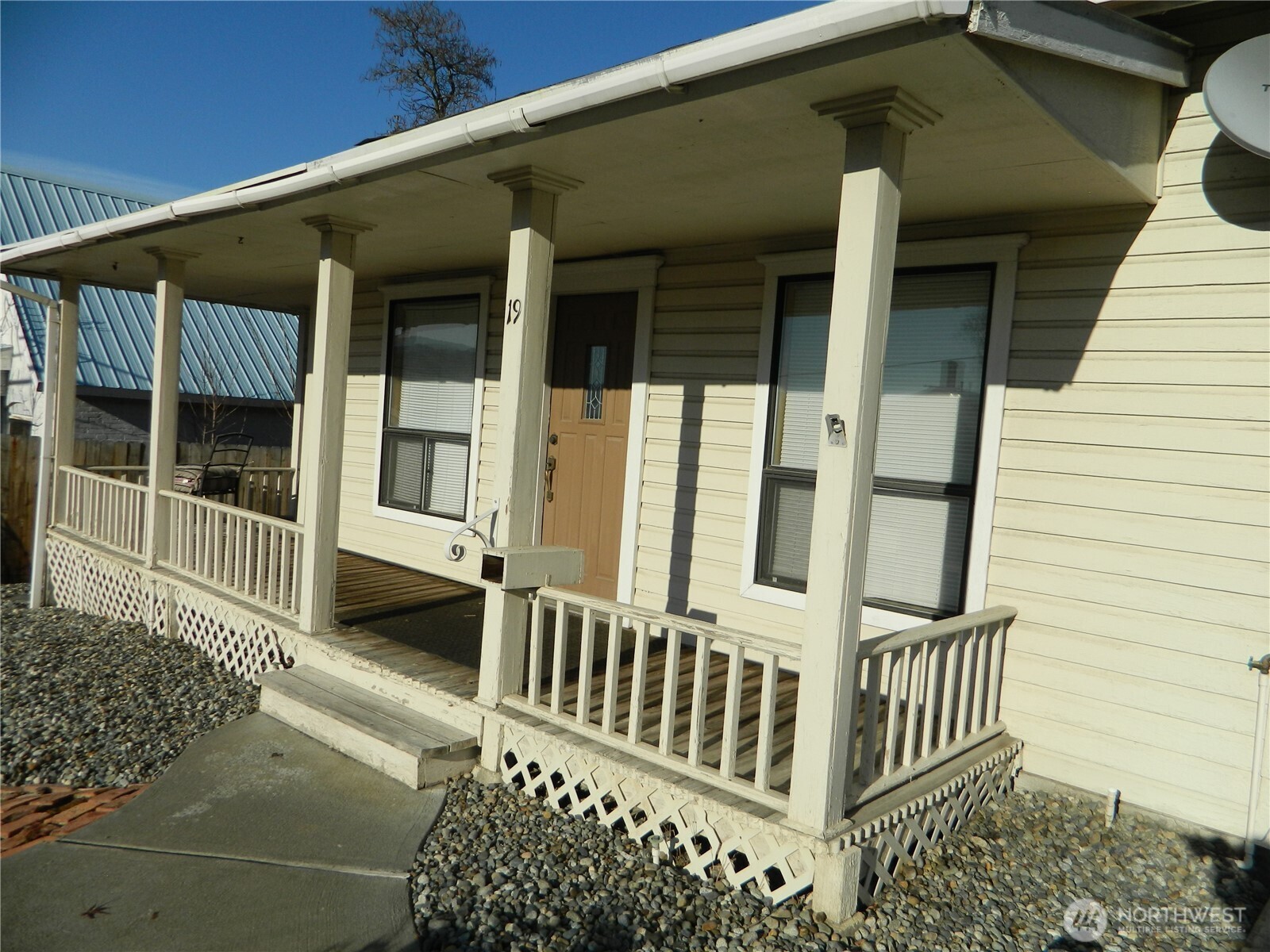 19 3rd Street Tonasket, WA 98855 - Photo 4 of 21 a porch with a chair