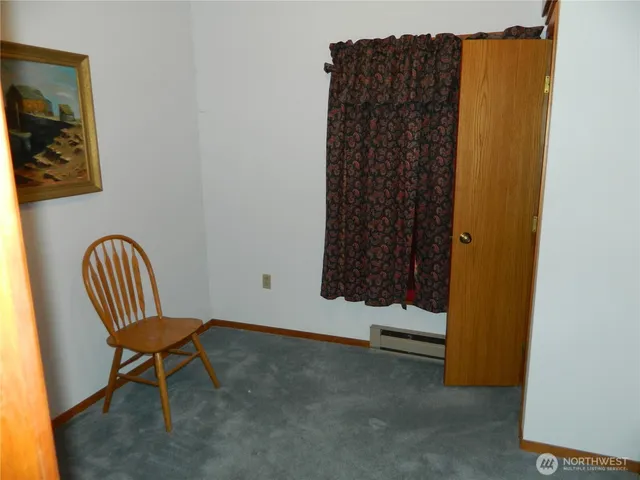 a view of a room with a window and a chair