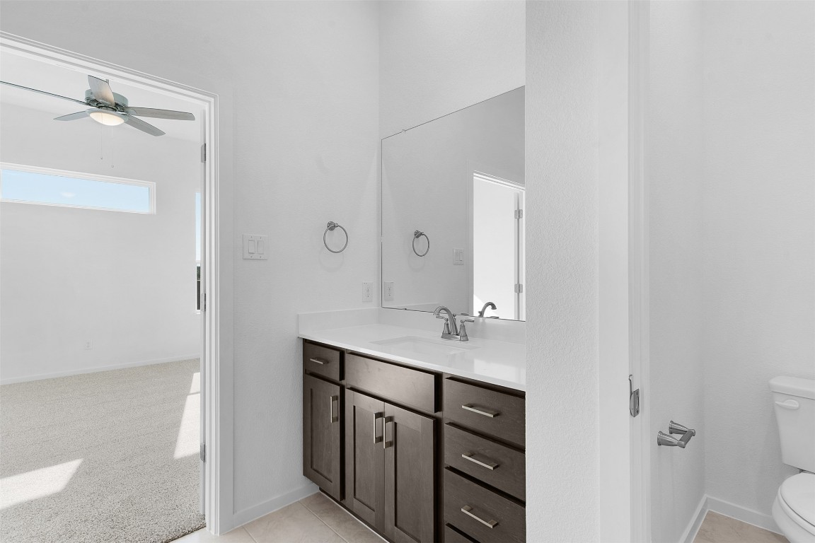 417 Raleigh Drive Georgetown, TX 78633 - Photo 11 of 29 Bathroom with light carpet, vanity, a ceiling fan, and light tile patterned floors
