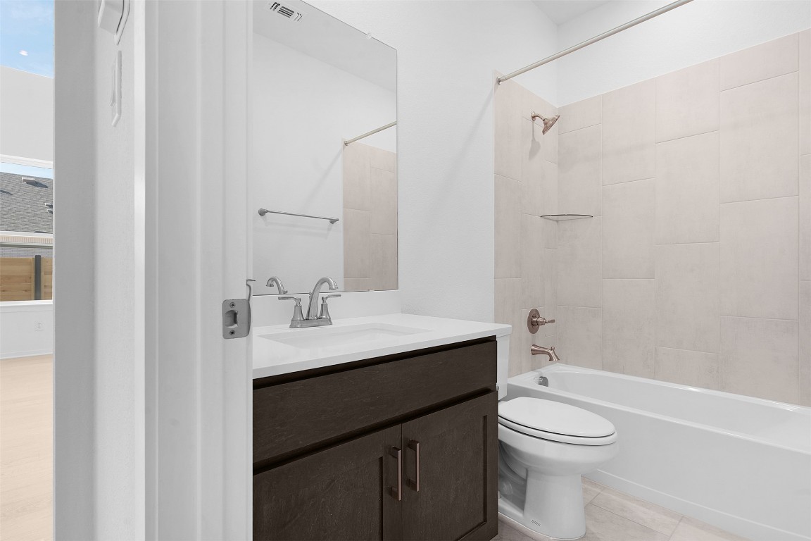 417 Raleigh Drive Georgetown, TX 78633 - Photo 15 of 29 Bathroom featuring vanity and washtub / shower combination