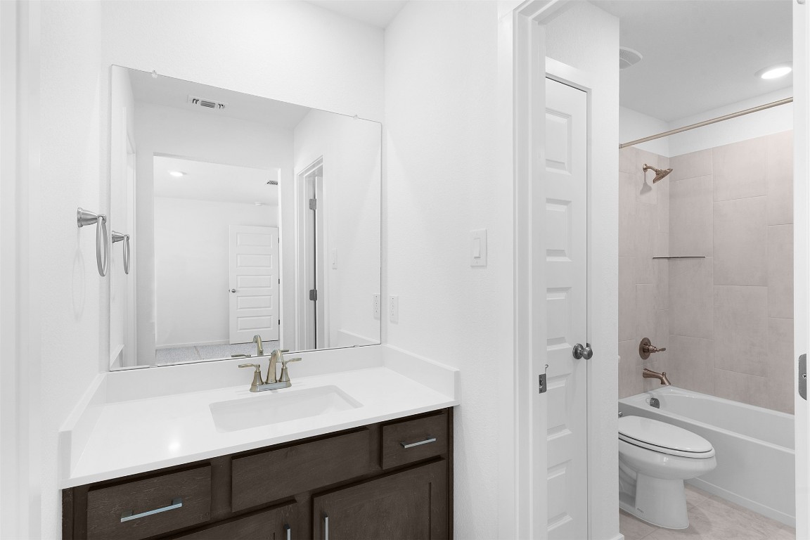 417 Raleigh Drive Georgetown, TX 78633 - Photo 20 of 29 Bathroom with vanity, bathing tub / shower combination, and recessed lighting