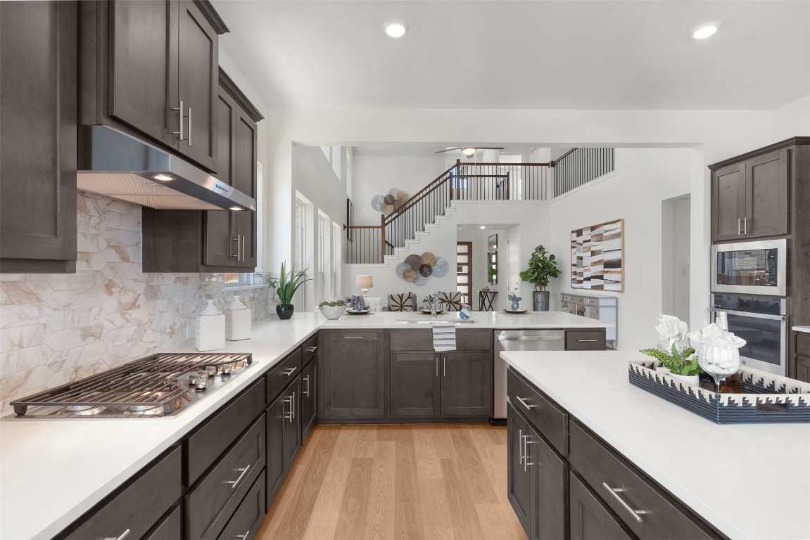 417 Raleigh Drive Georgetown, TX 78633 - Photo 29 of 40 a kitchen with stainless steel appliances a sink stove and cabinets