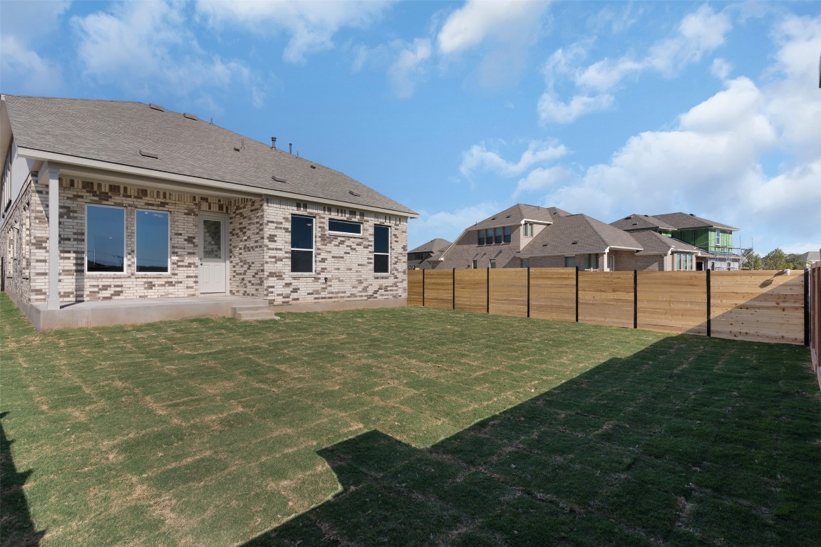 417 Raleigh Drive Georgetown, TX 78633 - Photo 23 of 29 Back of house featuring a patio, brick siding, a fenced backyard, and roof with shingles