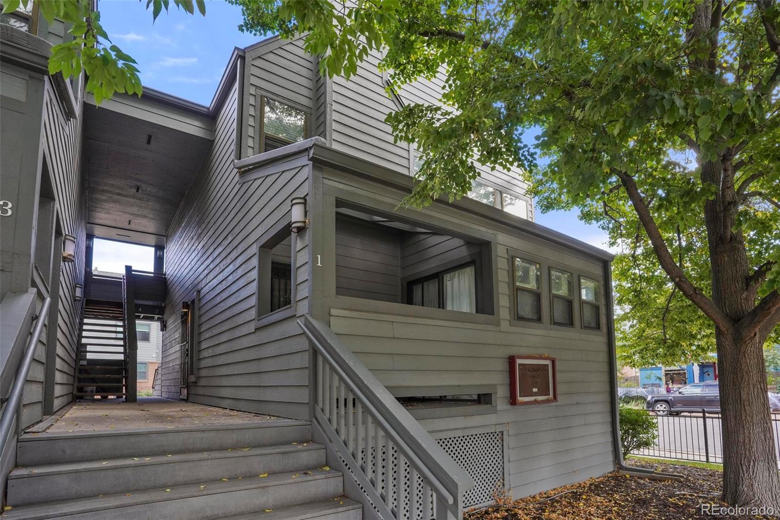 a view of a house with a small deck