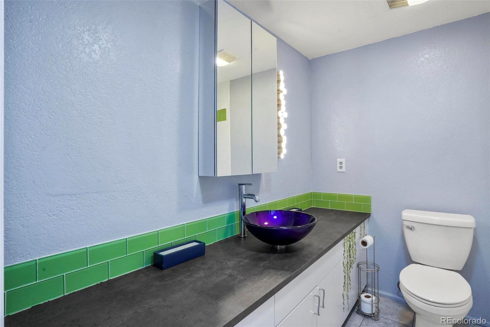 2 Acoma Street, Unit 1 Denver, CO 80223 - Photo 20 of 23 a bathroom with a toilet sink and mirror