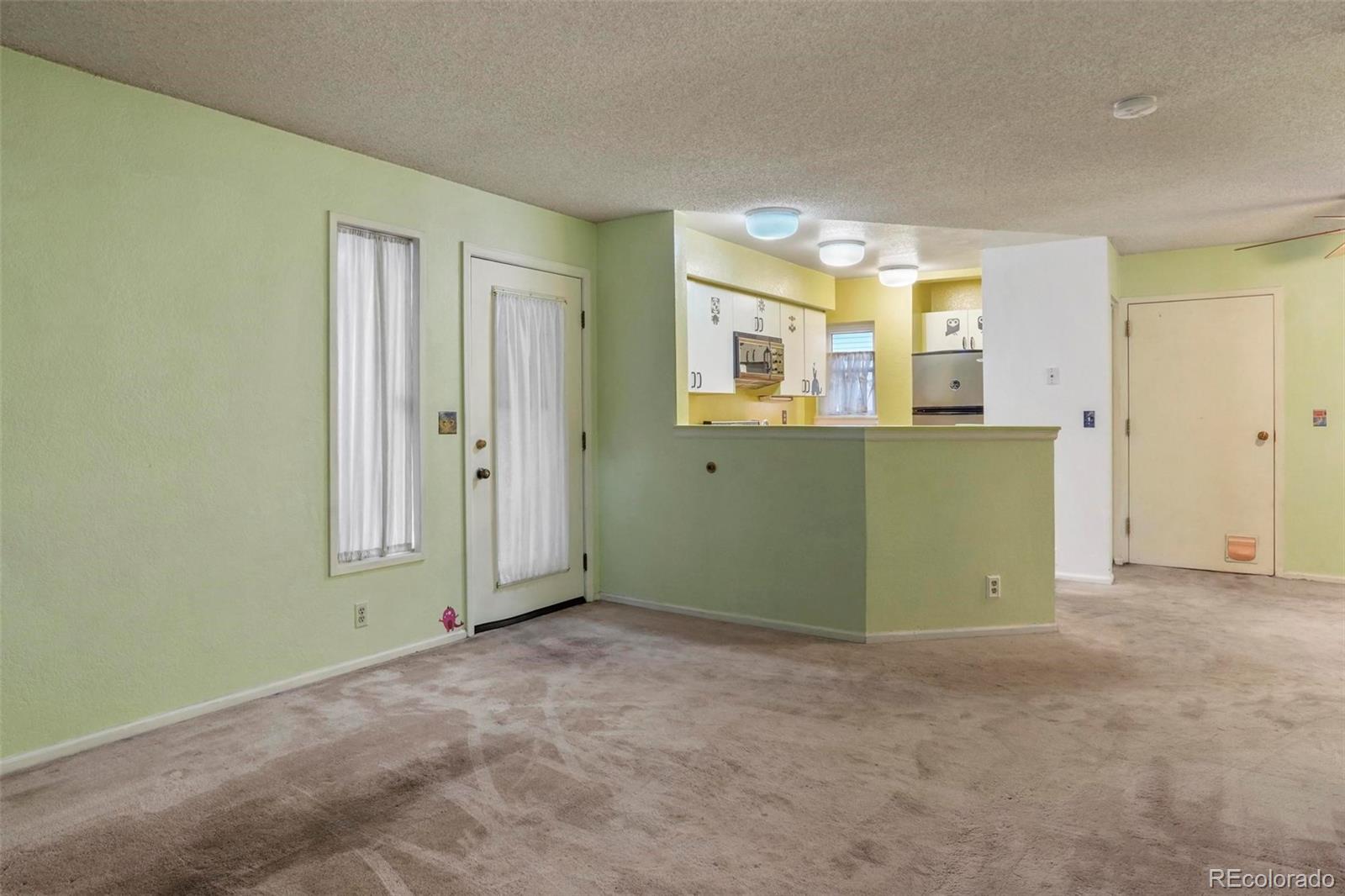 2 Acoma Street, Unit 1 Denver, CO 80223 - Photo 6 of 23 an empty room with windows