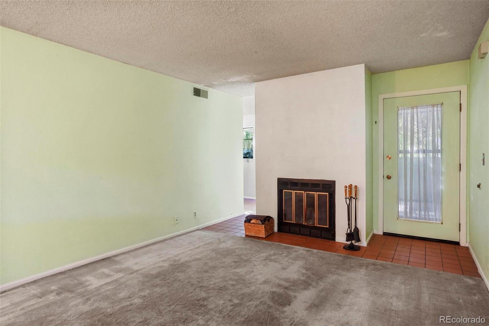 2 Acoma Street, Unit 1 Denver, CO 80223 - Photo 7 of 23 a view of an empty room with a fireplace