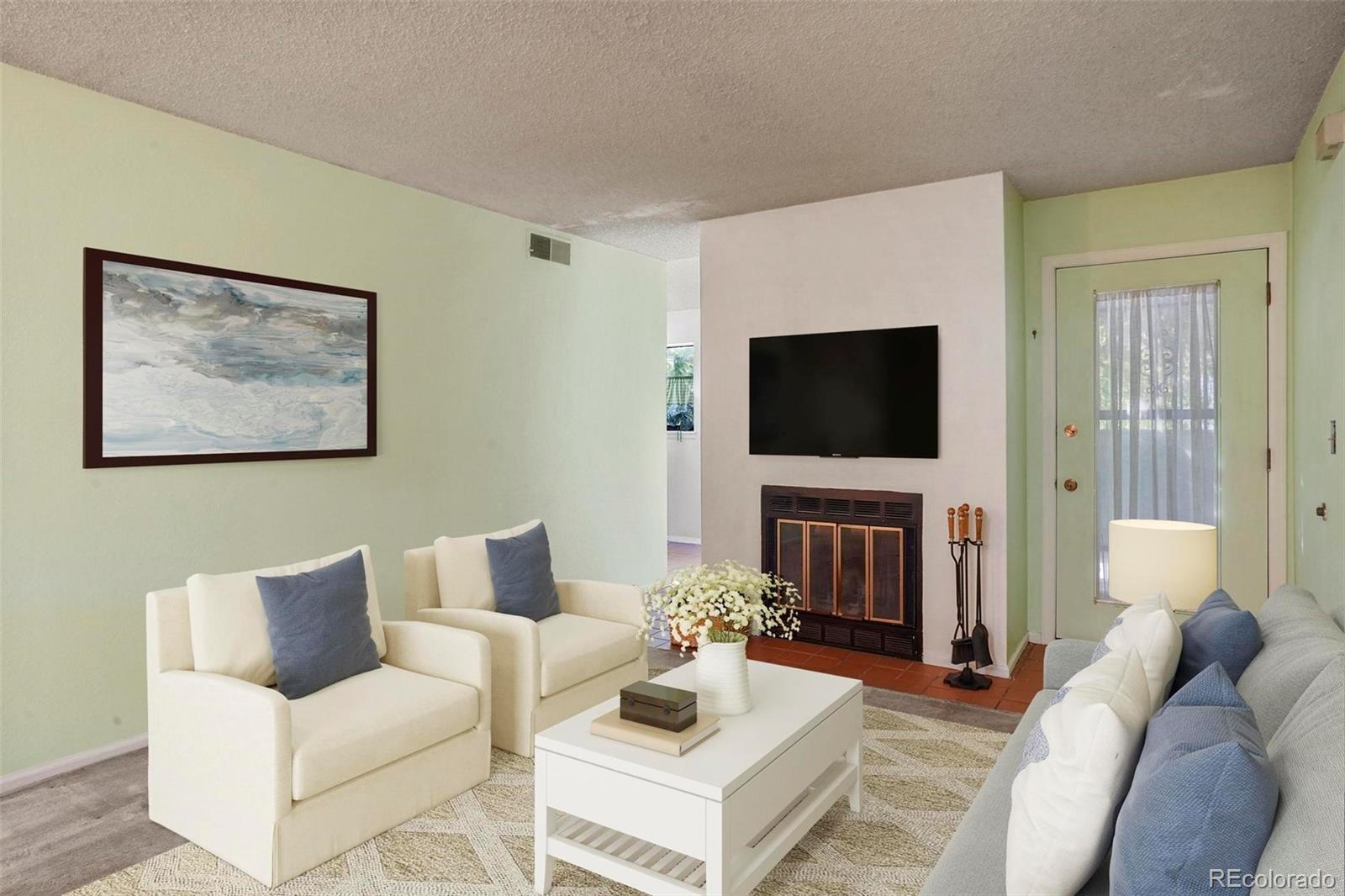 2 Acoma Street, Unit 1 Denver, CO 80223 - Photo 8 of 23 a living room with furniture and a flat screen tv