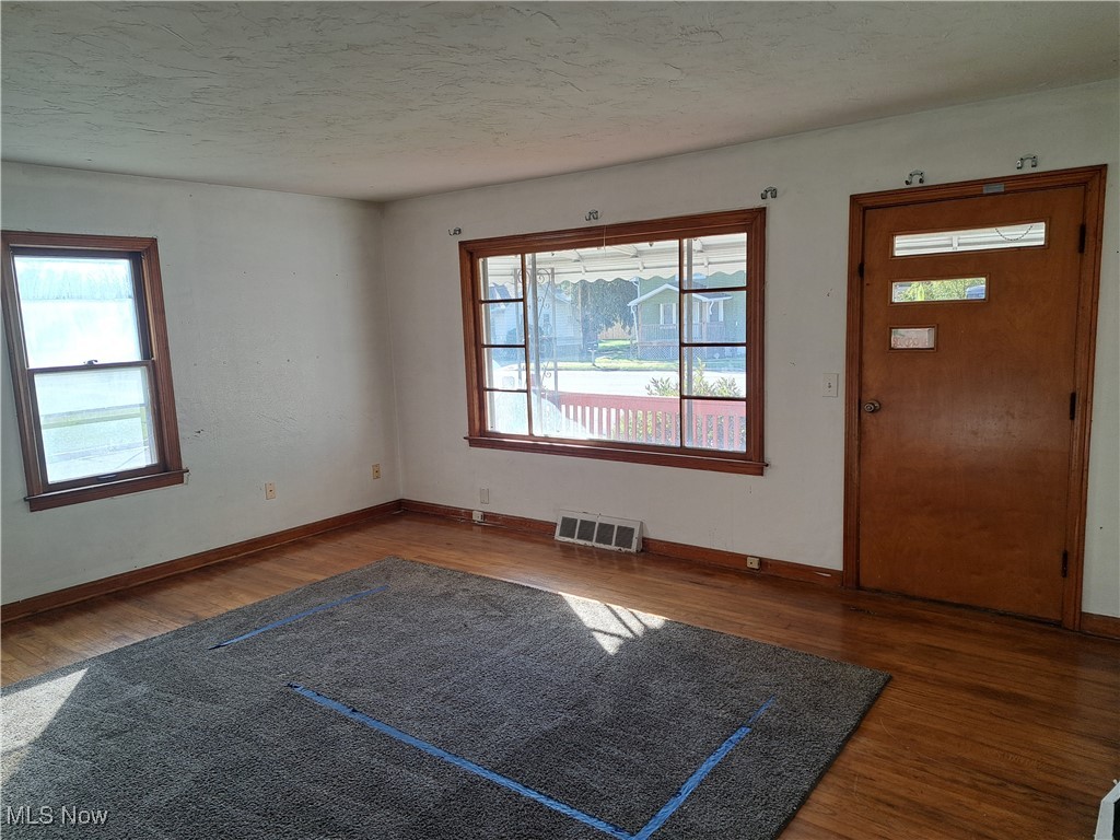 2245 North Ridge Road Lorain, OH 44055 - Photo 5 of 24 Entrance foyer featuring a textured ceiling and dark hardwood / wood-style floors