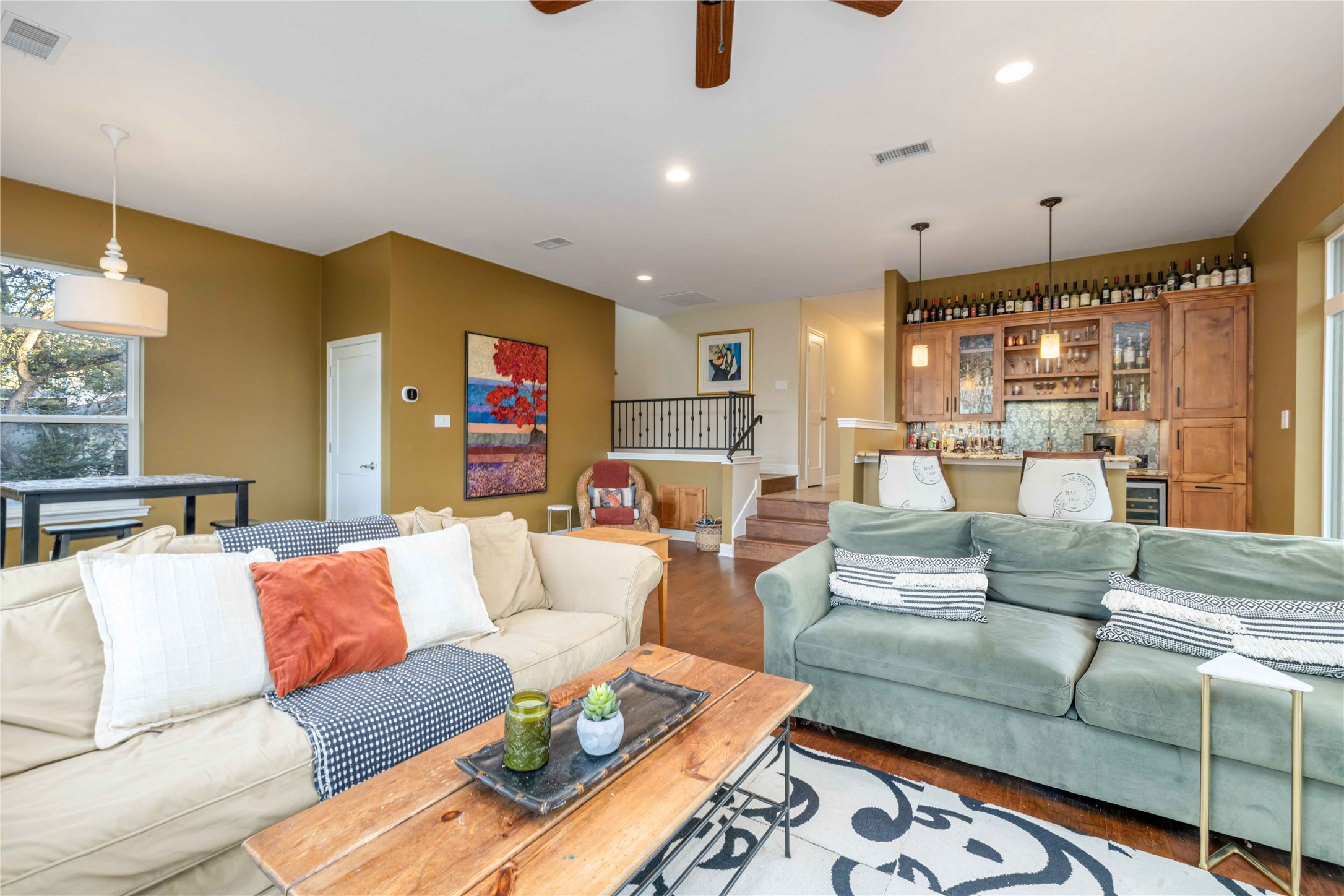 10903 Cade Circle Austin, TX 78726 - Photo 26 of 40 Living area featuring wood finished floors, ceiling fan, recessed lighting, bar, and wine cooler