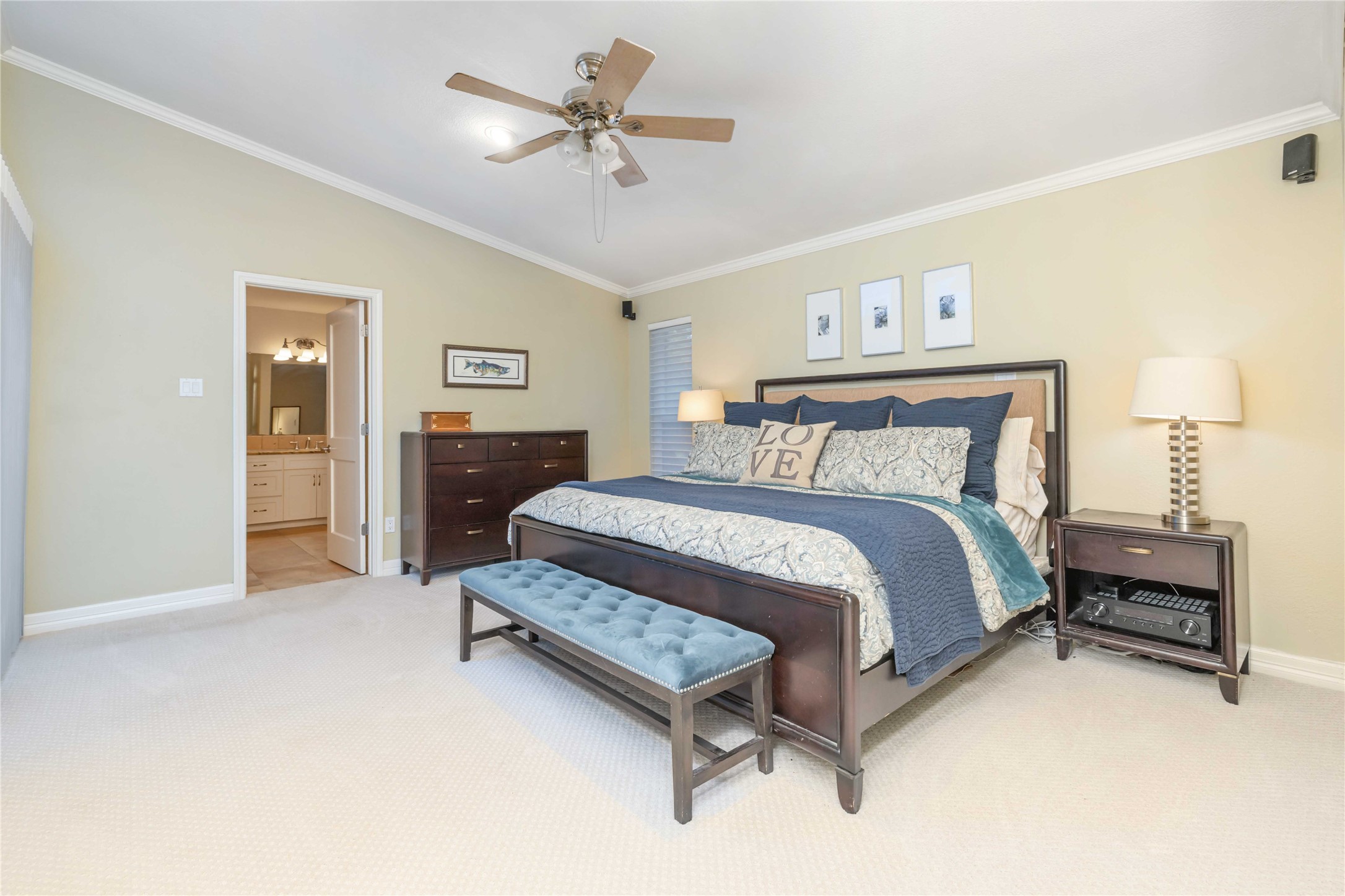 10903 Cade Circle Austin, TX 78726 - Photo 30 of 40 Bedroom with light colored carpet, crown molding, lofted ceiling, a ceiling fan, and ensuite bathroom