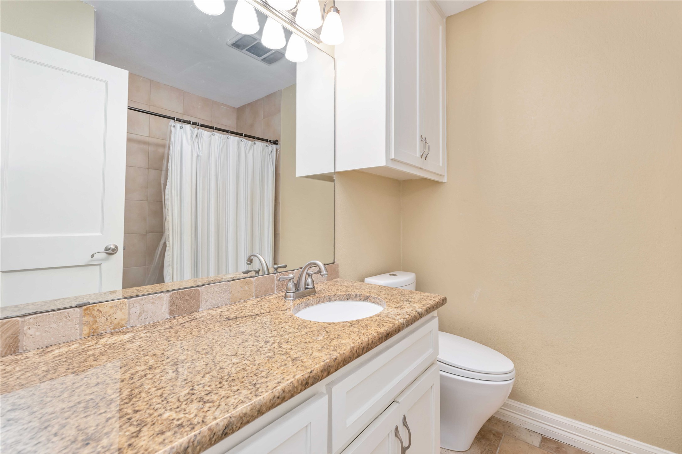 10903 Cade Circle Austin, TX 78726 - Photo 36 of 40 Full bathroom featuring vanity and curtained shower