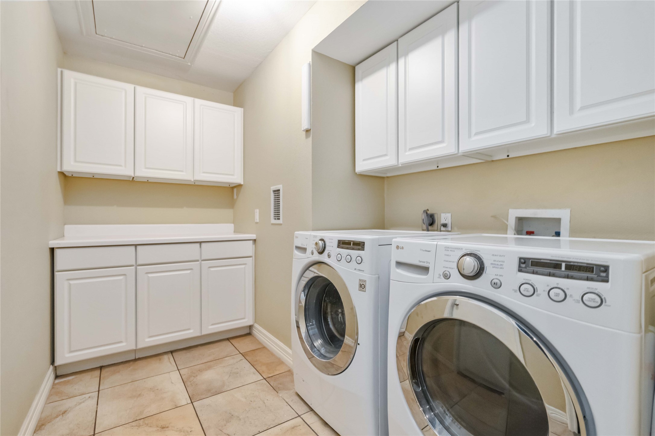 10903 Cade Circle Austin, TX 78726 - Photo 37 of 40 Laundry area with cabinet space, independent washer and dryer, and light tile patterned floors