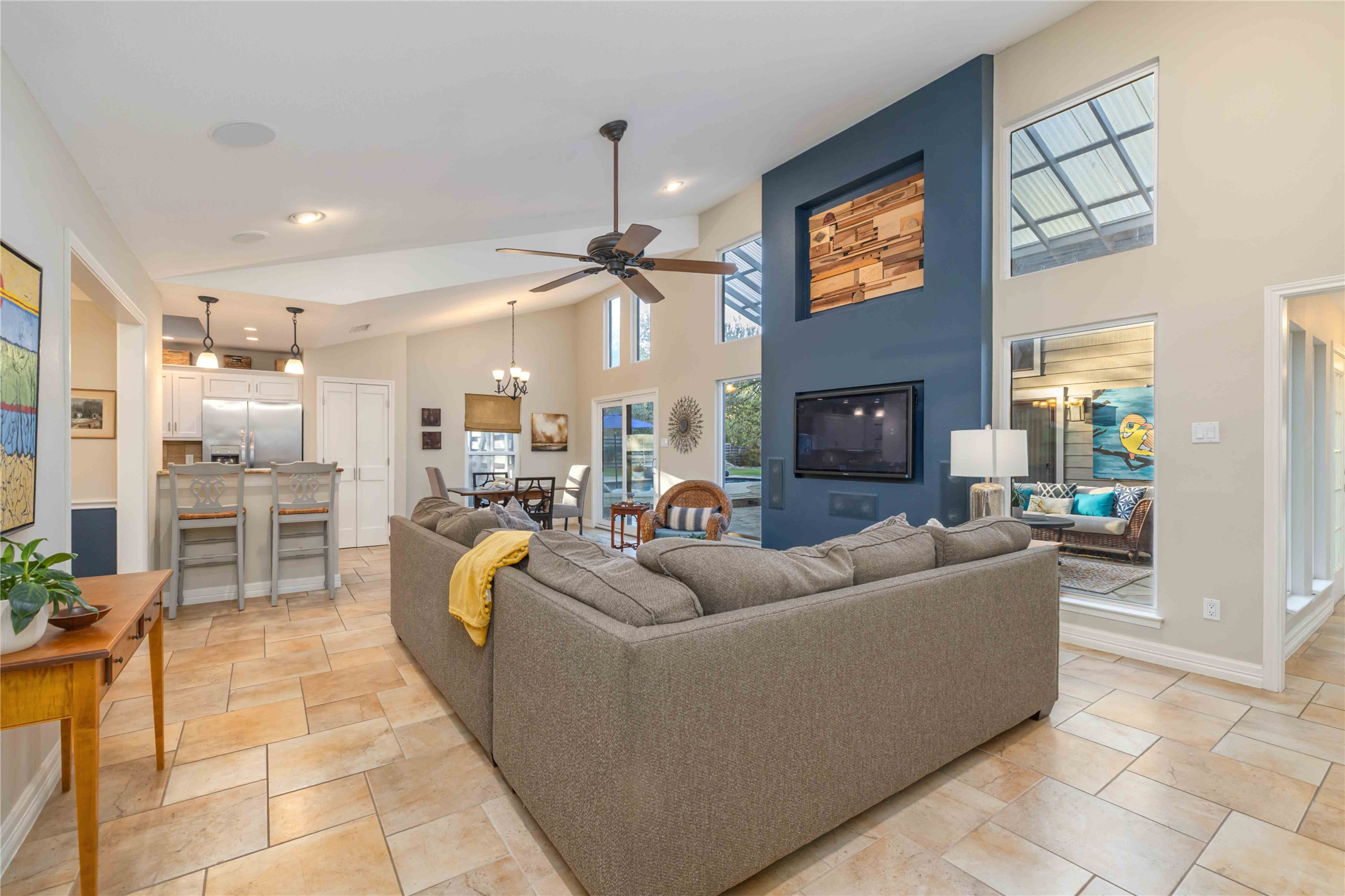 10903 Cade Circle Austin, TX 78726 - Photo 4 of 40 Living area with a high ceiling, a ceiling fan, and a chandelier