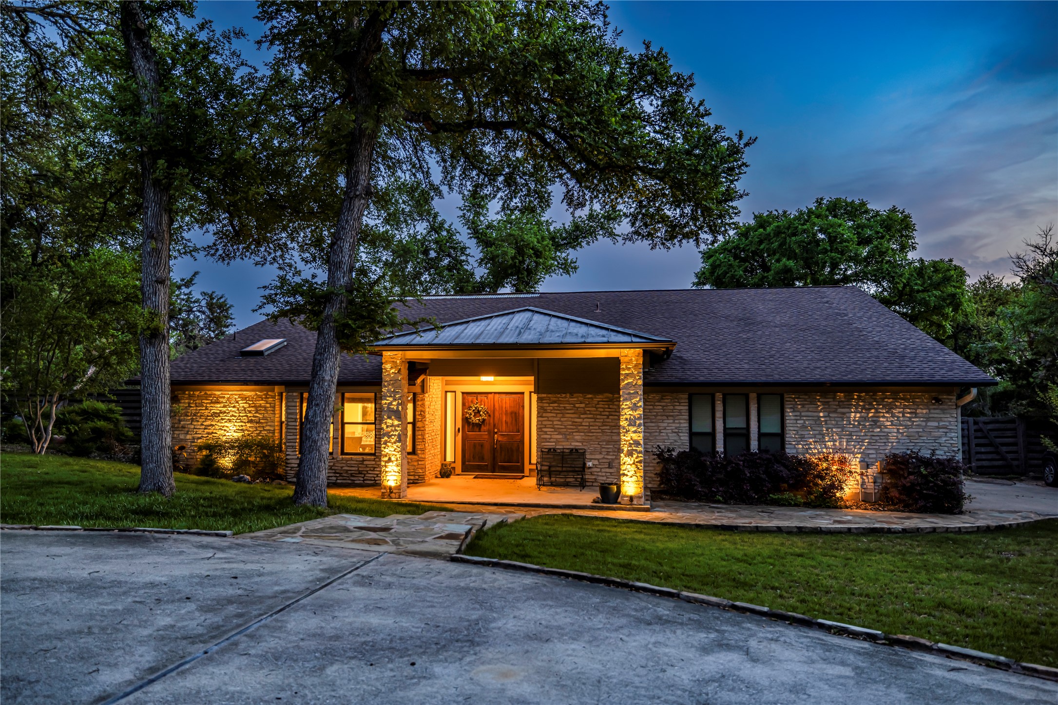 10903 Cade Circle Austin, TX 78726 - Photo 9 of 40 View of front facade with a front lawn, brick siding, and a standing seam roof