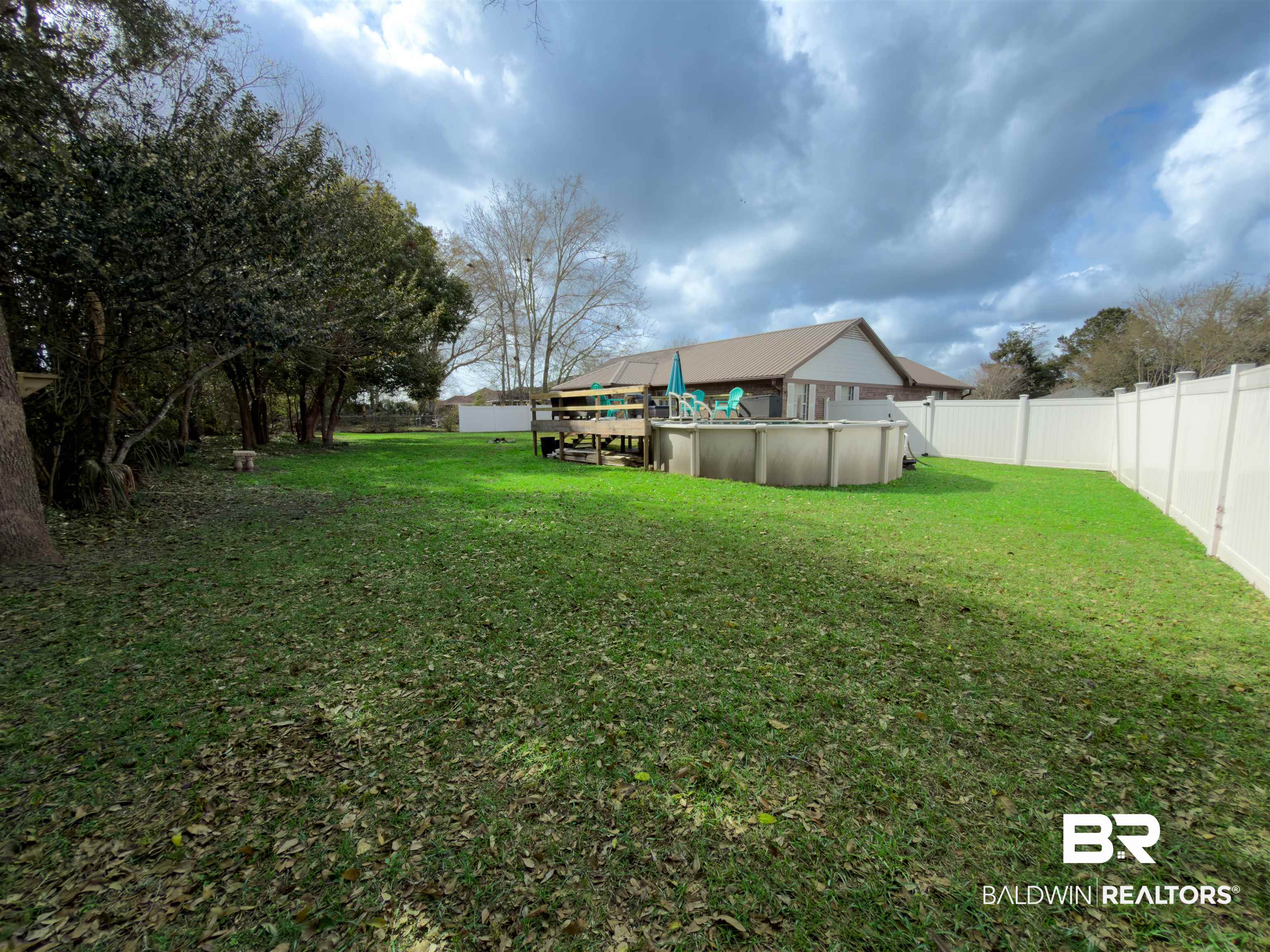 129 Pennbrooke Loop Foley, AL 36535 - Photo 41 of 44 Fenced backyard featuring an outdoor pool and a deck