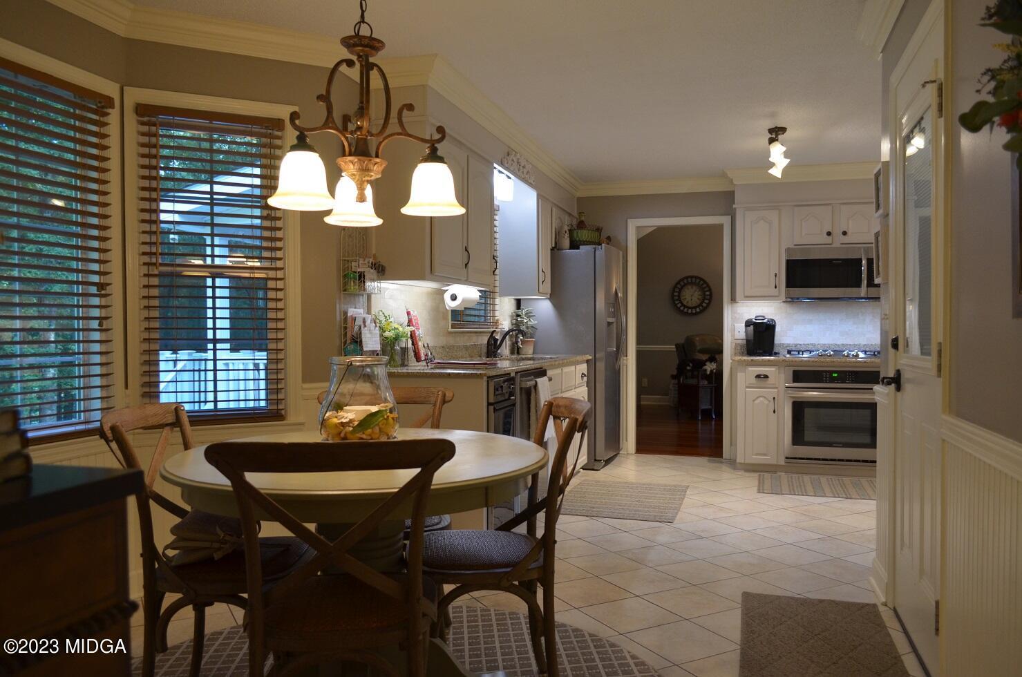 76 Riverside Landing Macon, GA 31210 - Photo 13 of 44 a dining room with furniture a chandelier and kitchen view