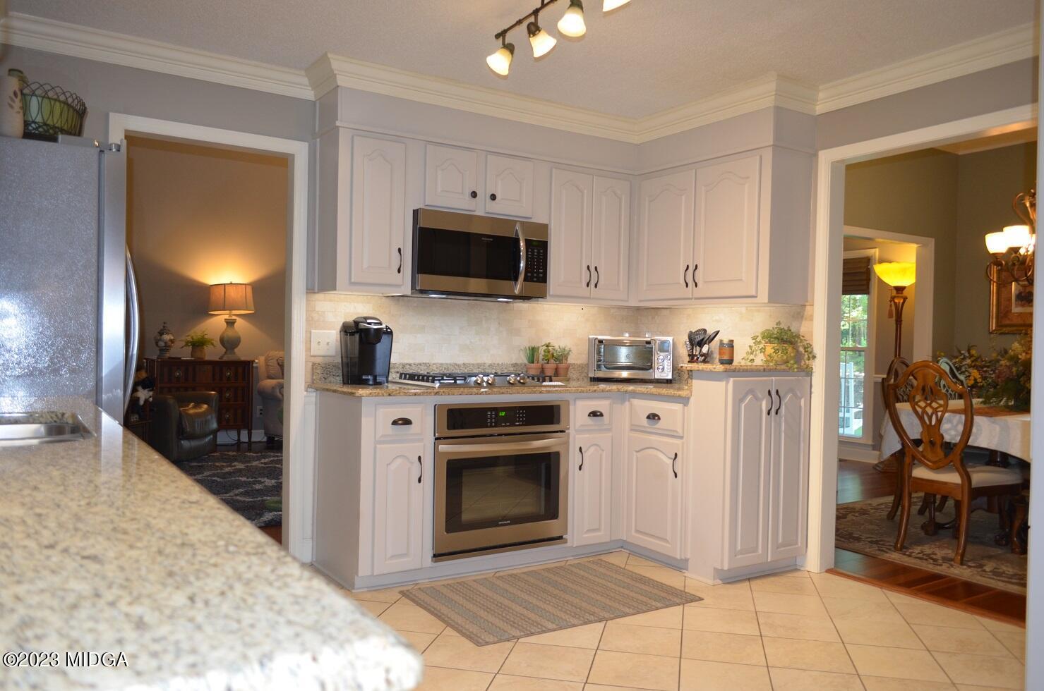 76 Riverside Landing Macon, GA 31210 - Photo 15 of 44 a kitchen with stainless steel appliances a stove a sink and a microwave