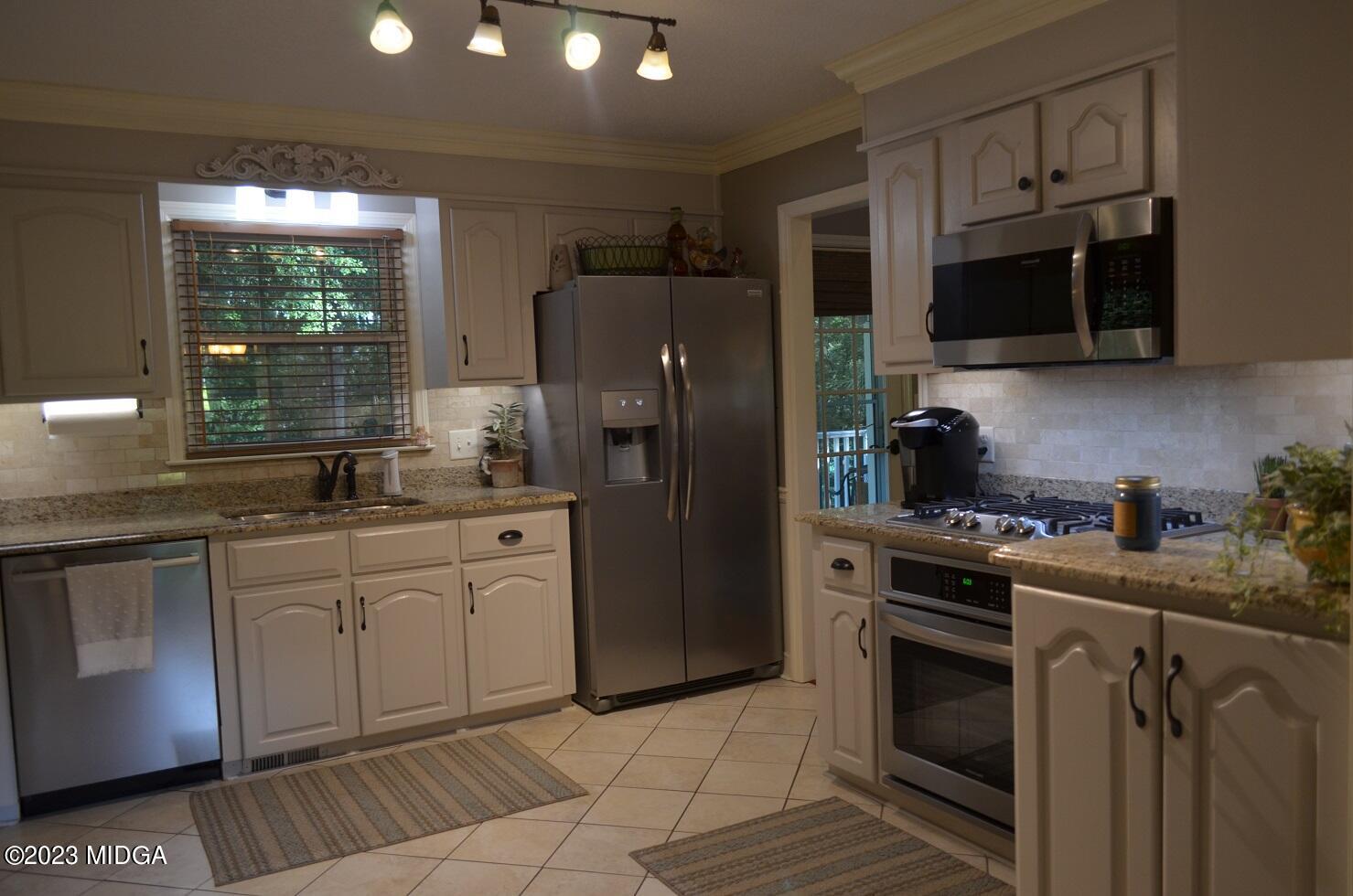 76 Riverside Landing Macon, GA 31210 - Photo 16 of 44 a kitchen with stainless steel appliances granite countertop a stove a sink dishwasher a refrigerator and a microwave oven with granite countertops