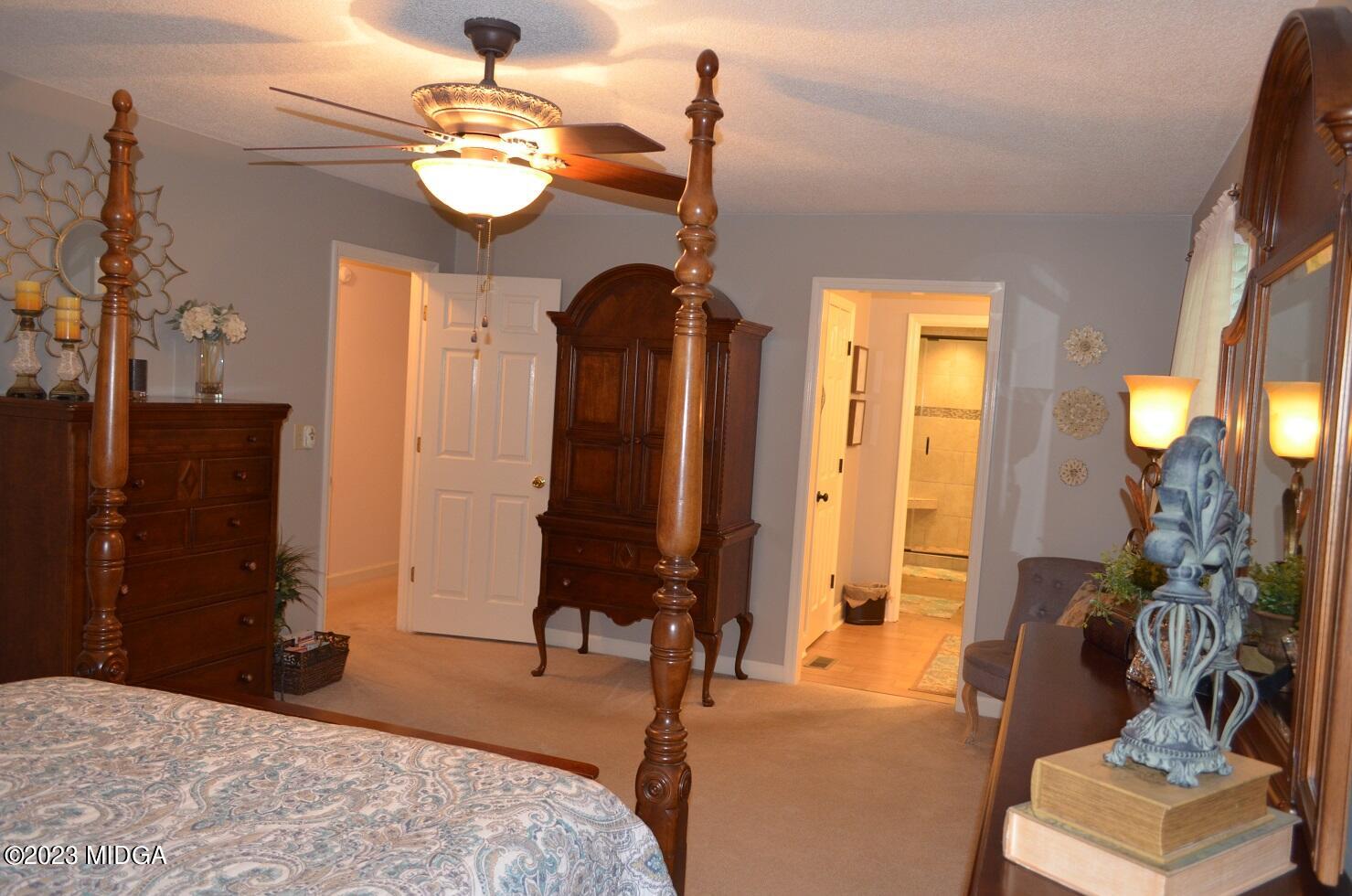 76 Riverside Landing Macon, GA 31210 - Photo 20 of 44 a bedroom with a bed and a chandelier
