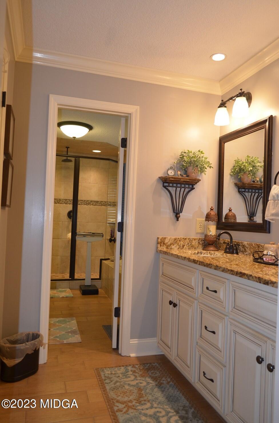 76 Riverside Landing Macon, GA 31210 - Photo 21 of 44 a bathroom with a granite countertop sink and a mirror