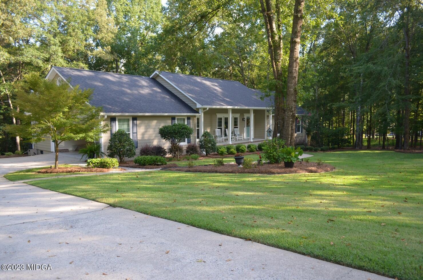 76 Riverside Landing Macon, GA 31210 - Photo 4 of 44 a front view of a house with garden and trees