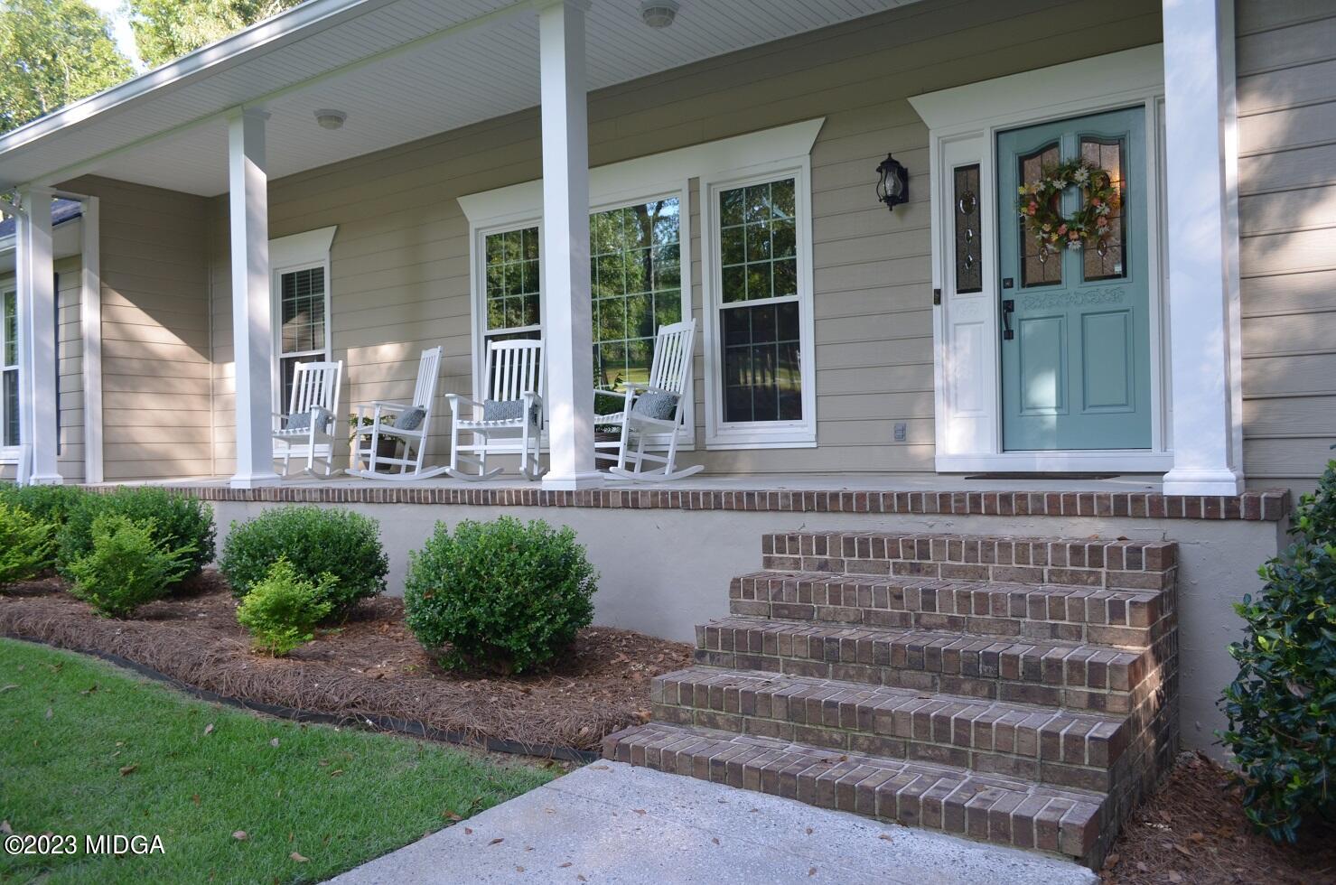 76 Riverside Landing Macon, GA 31210 - Photo 6 of 44 a front view of a house with outdoor seating and plants