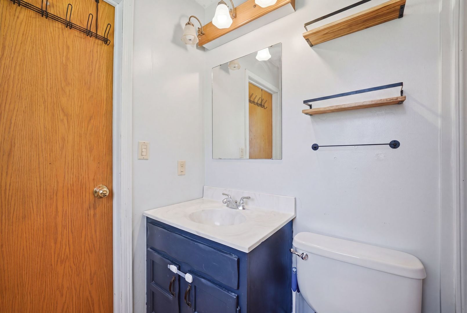 5645 Beebe Drive Rochelle, IL 61068 - Photo 25 of 43 a bathroom with a sink toilet and mirror