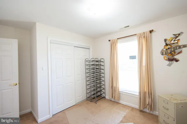 a hallway with painting on the wall and a window