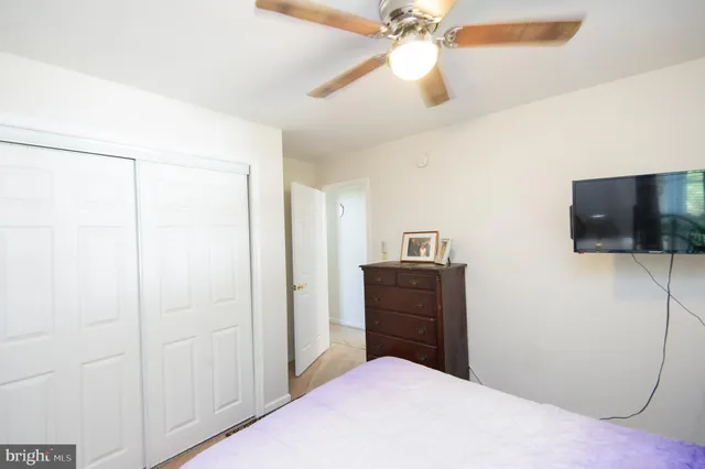 a bedroom with a bed and a fan