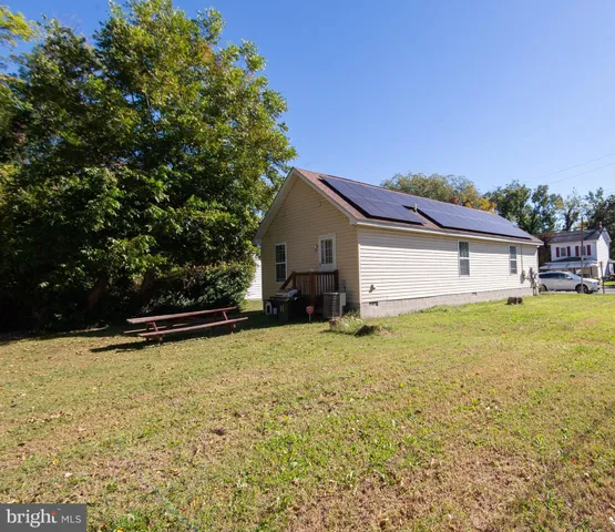 a view of a porch with a table and chairs