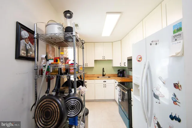 a kitchen with stainless steel appliances a stove microwave and sink