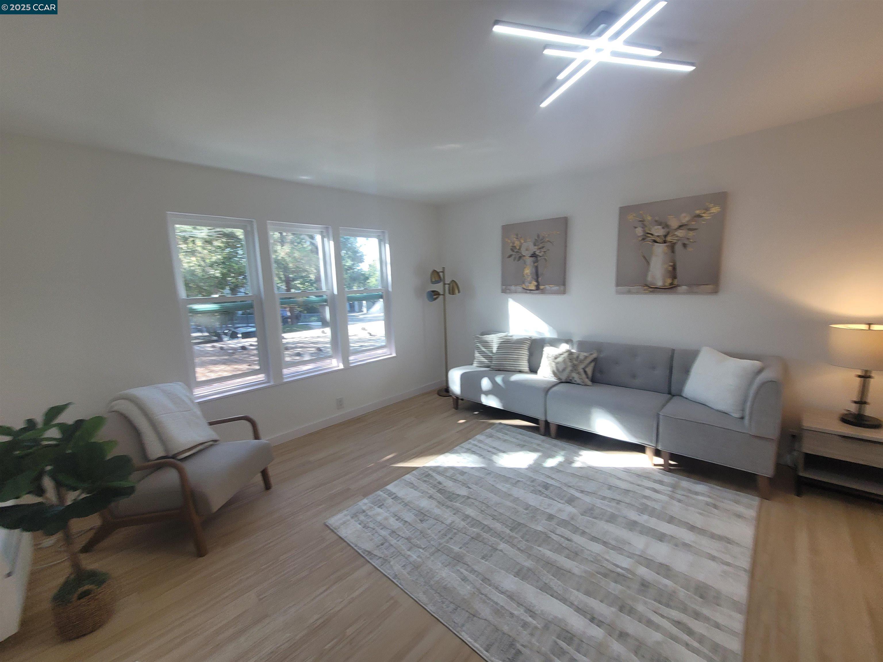 375 Camelback Road, Unit 23 Pleasant Hill, CA 94523 - Photo 2 of 42 a living room with furniture and a large window