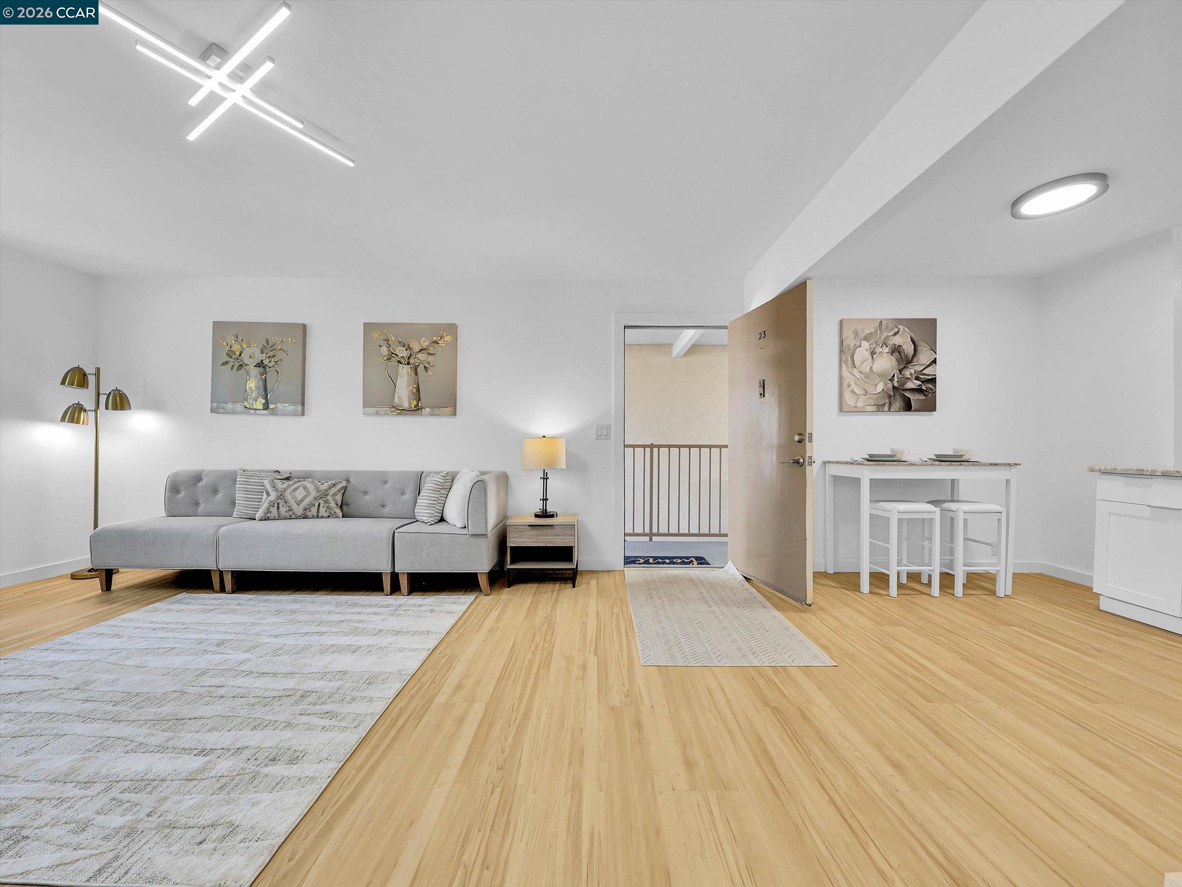 375 Camelback Road, Unit 23 Pleasant Hill, CA 94523 - Photo 3 of 58 a spacious bedroom with a bed a table and painting on the wall