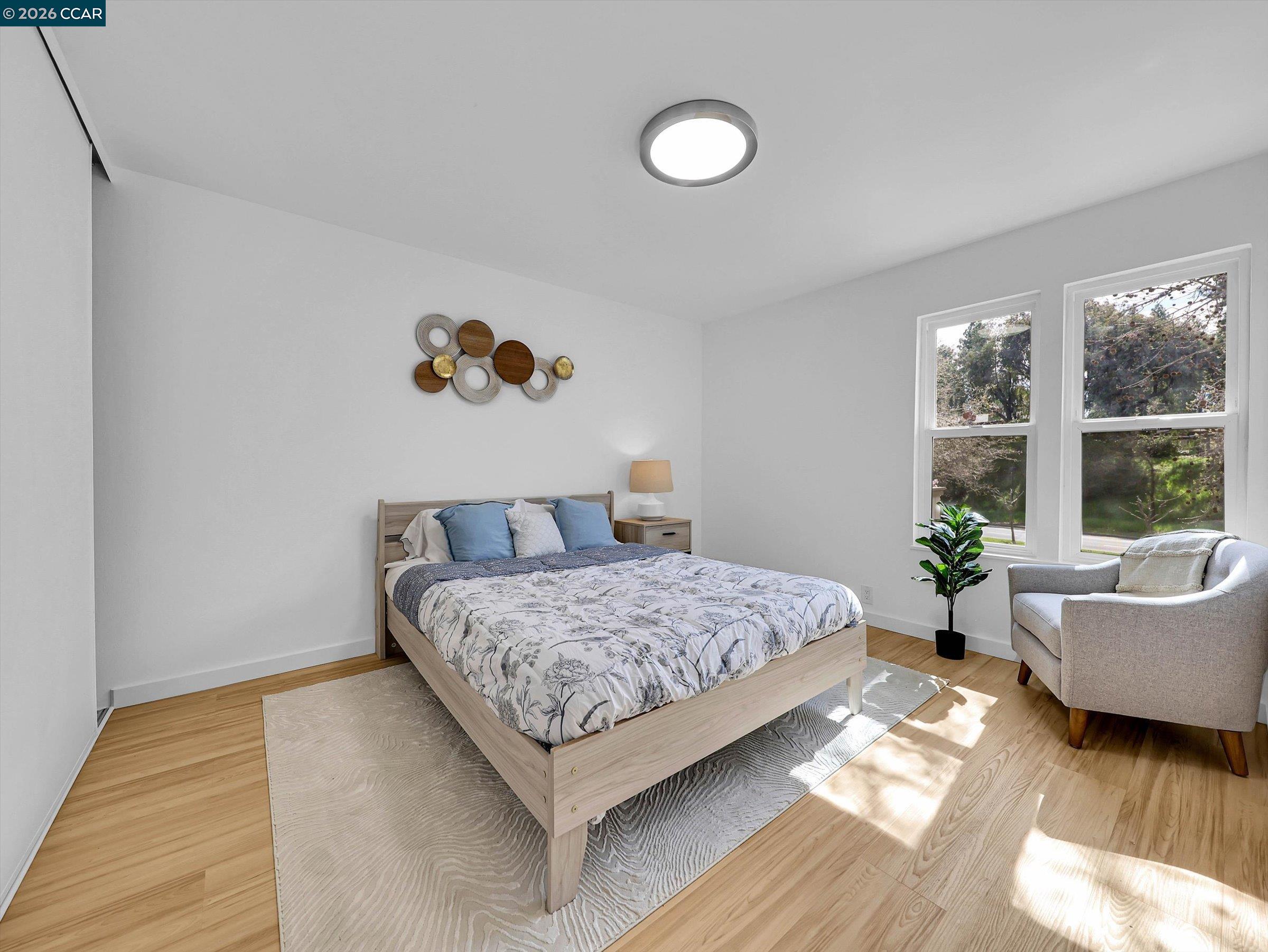 375 Camelback Road, Unit 23 Pleasant Hill, CA 94523 - Photo 32 of 58 a bedroom with a bed and wooden floor