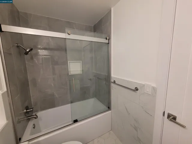 a view of a livingroom with an empty space and a hallway