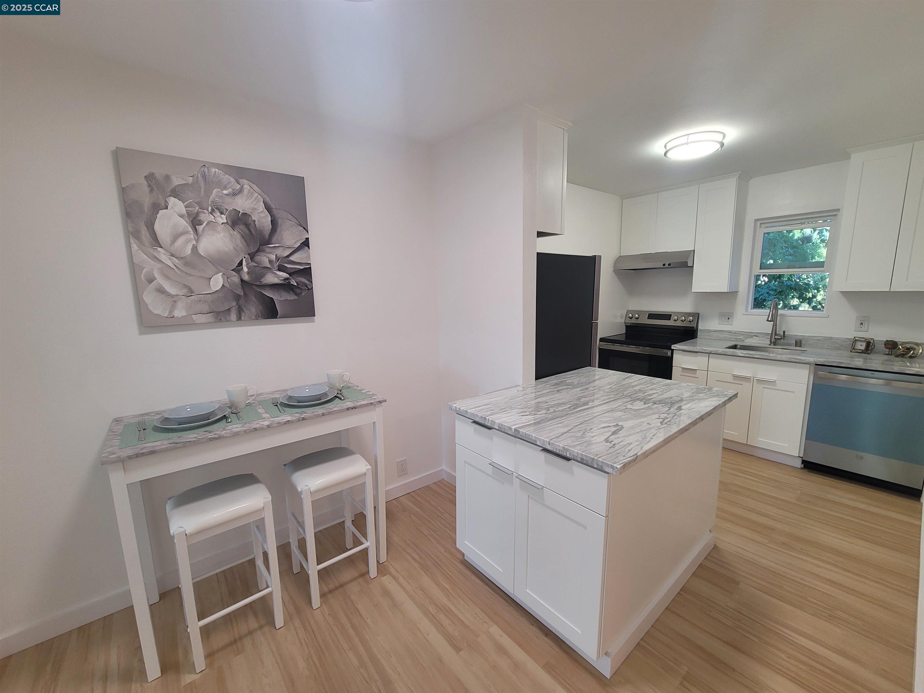 375 Camelback Road, Unit 23 Pleasant Hill, CA 94523 - Photo 4 of 42 a kitchen with a cabinets and chairs