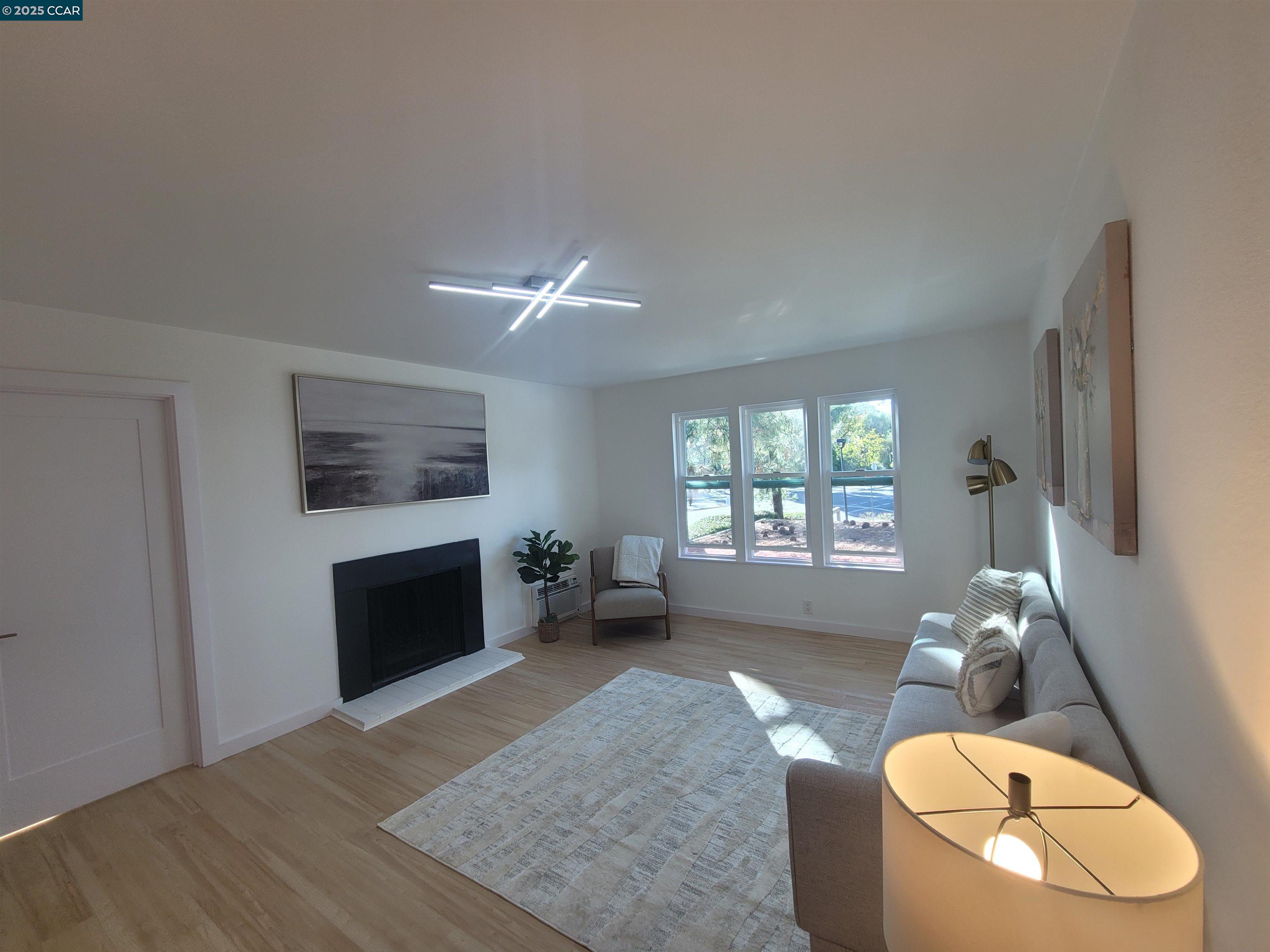 375 Camelback Road, Unit 23 Pleasant Hill, CA 94523 - Photo 9 of 42 a living room with furniture and a fireplace