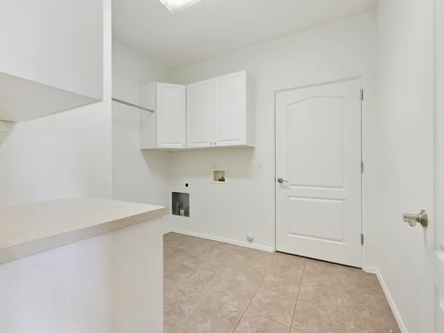 a view of a kitchen with white cabinets