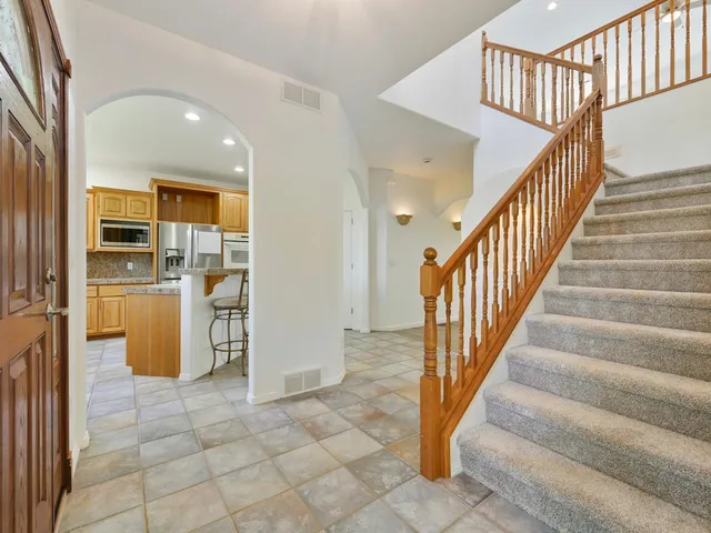 a view of entryway and hall with a living room