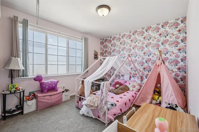 a bedroom with bed and a window