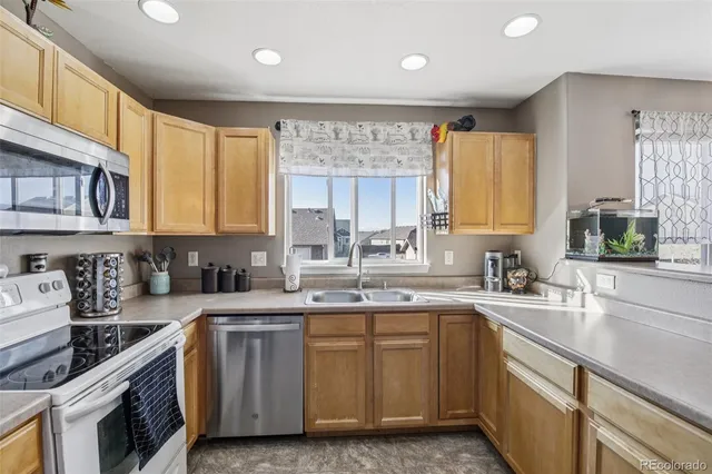 a kitchen with a sink stove and cabinets