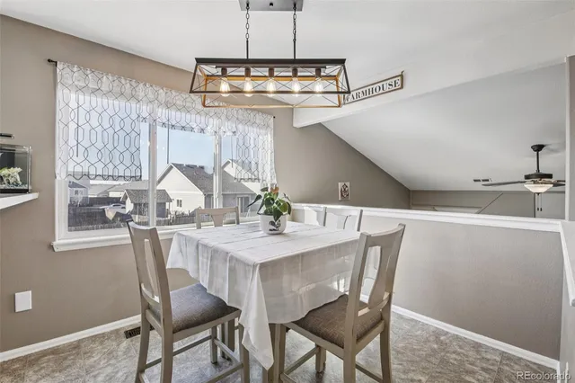a view of a dining room with furniture and chandelier