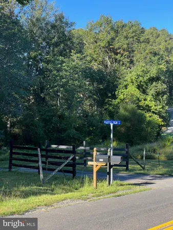 a view of backyard with swimming pool and sitting area