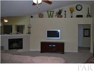 4871 Pineview Ridge Road Pace, FL 32571 - Photo 2 of 16 Great Room with plant ledges, vaulted ceiling, and fireplace