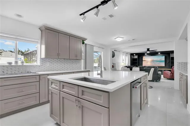 a kitchen that has a sink and a stove in it