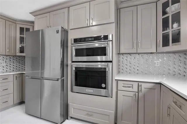 a kitchen with cabinets and stainless steel appliances
