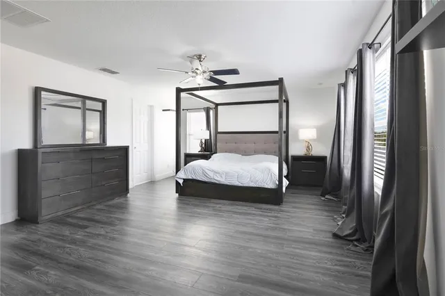 a bedroom with a bed and a mirror