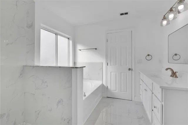 a bathroom with white walls