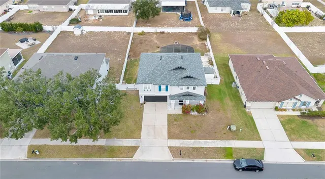 an aerial view of a house with a yard